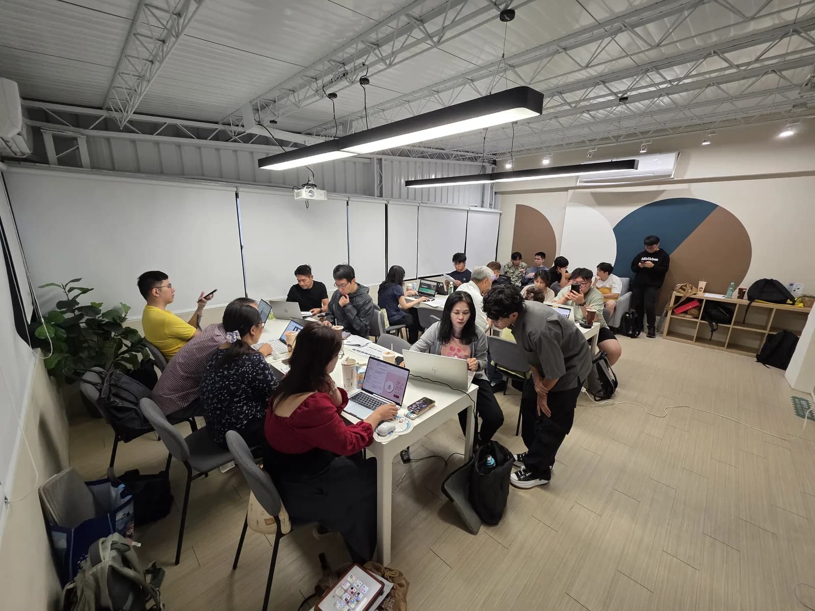 另一場實體工作坊中，Ray 協助學員操作筆電